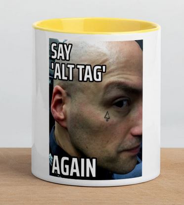 'Say ALT TAG AGAIN' says Adrian, replete with mouse cursor tattoo below his eye, looking menacingly out of a mug. White Mug, yellow inside and handle.