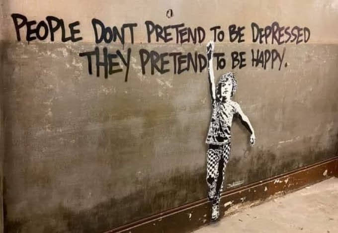 Street art on a concrete wall featuring a stencil of a young girl with her arm raised. The text above the girl reads, 'PEOPLE DON'T PRETEND TO BE DEPRESSED, THEY PRETEND TO BE HAPPY.'