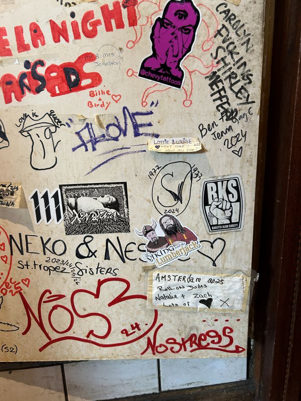 V&L sticker I stuck on a coffee shop sticker/grafitti wall in Amsterdam 2026